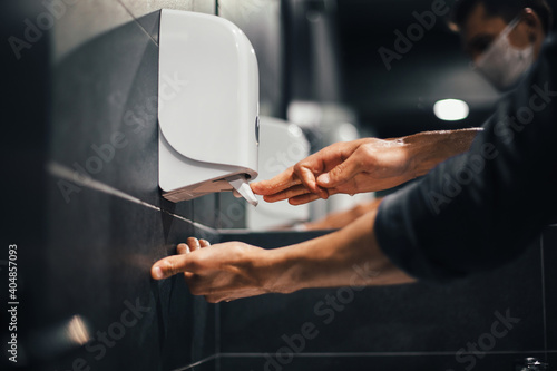 Obraz na płótnie top view. a man carefully washes his hands in the bathroom w salonie