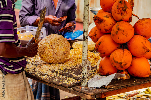 Preparing of a coconut for drinking on a Colombo market at Sri Lanka
