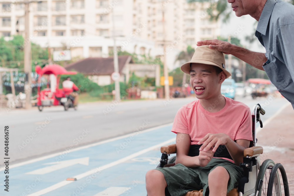 Disabled child on wheelchair is smiling,playing,learning in outdoor street activity like other people,Lifestyle of special child, Life in the education age of children, Happy disability kid concept.