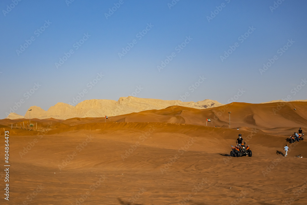 Desert dunes at Al Awir desert near Dubai with buggy vehicle at sunset light. Dubai, United Arab Emirates, Middle East. Desert dunes at Al Awir desert near Dubai with buggy vehicle at sunset light. Dubai, United Arab Emirates, Middle East.