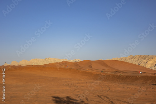 Desert dunes at Al Awir desert near Dubai with buggy vehicle at sunset light. Dubai  United Arab Emirates  Middle East.