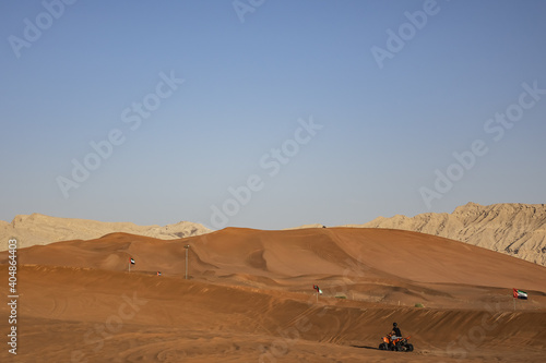 Desert dunes at Al Awir desert near Dubai with buggy vehicle at sunset light. Dubai  United Arab Emirates  Middle East.