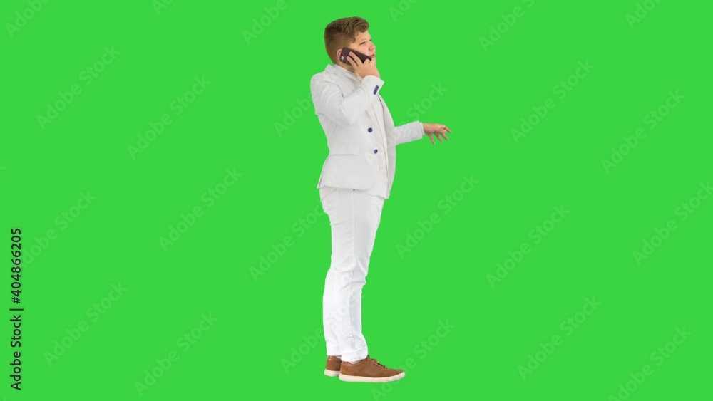 Businessman boy making a call with smartphone on a Green Screen, Chroma Key. Businessman boy making a call with smartphone on a Green Screen, Chroma Key.