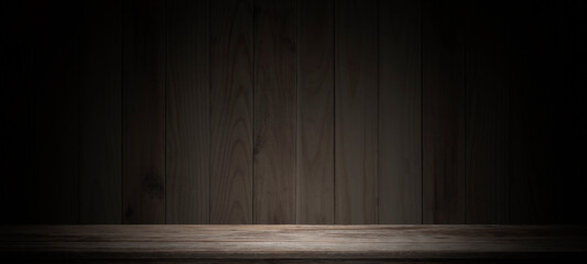 Empty wooden table on dark background,used as a studio background wall to display your products.
