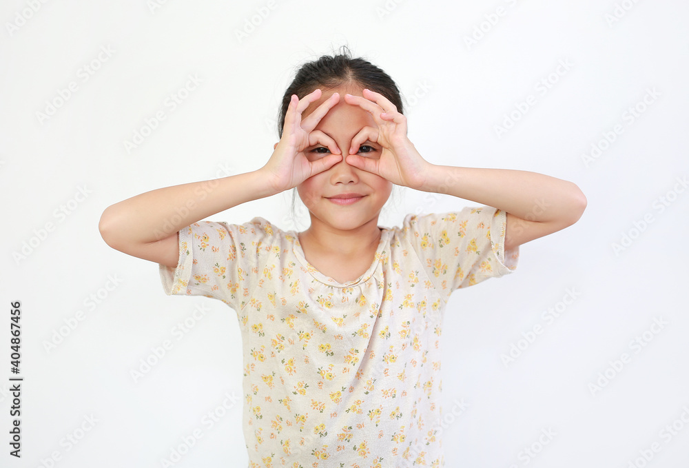 Cute young asian little girl looking through imaginary binocular isolated on white background. Cute young asian little girl looking through imaginary binocular isolated on white background.