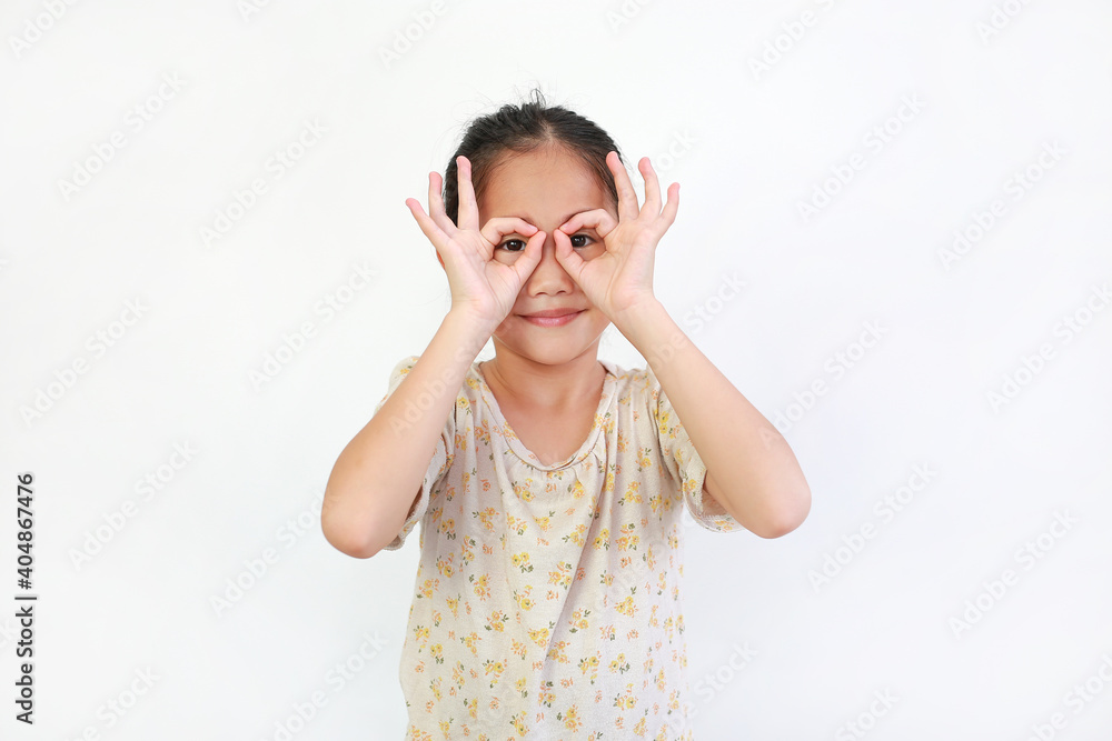 Young asian little girl looking through imaginary binocular isolated on white background. Young asian little girl looking through imaginary binocular isolated on white background.