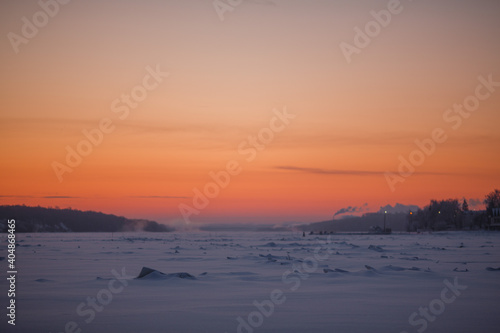 Dawn in the winter on the ice-covered river. Winter morning. © vov8000