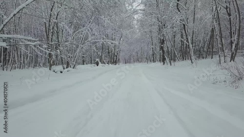 Wallpaper Mural Flying drone camera on a snowy forest road in snowy weather in the forest on a winter day. Torontodigital.ca
