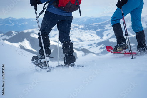 Two snow shoe hikers walking down from Kronberg, a mountain in Switzerland
