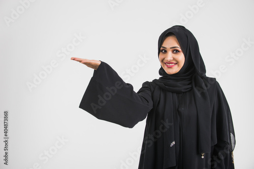 Photography Beautiful woman from Dubai posing on colored background with traditional abaya