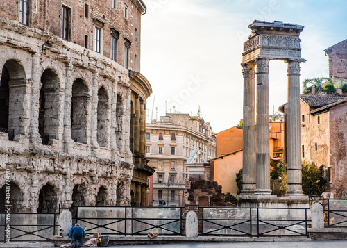 Photography A street of Rome with ancient and medieval houses at sunset and a praying man