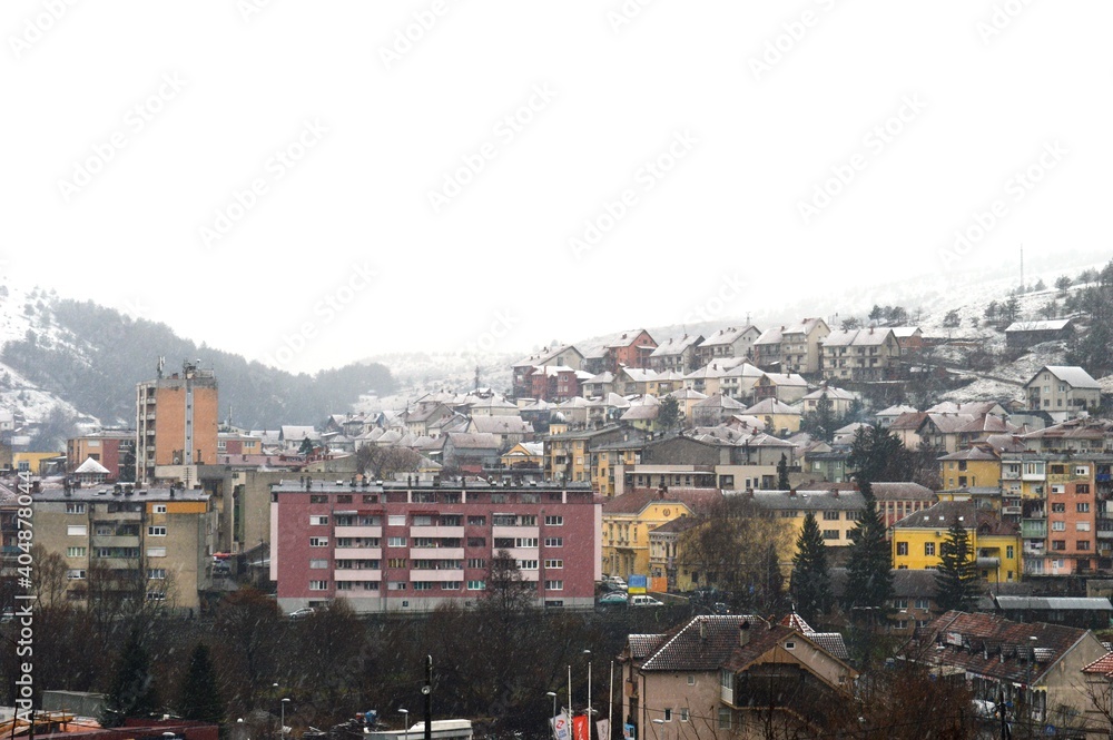 Fototapeta premium houses and buildings of various colors on the snow