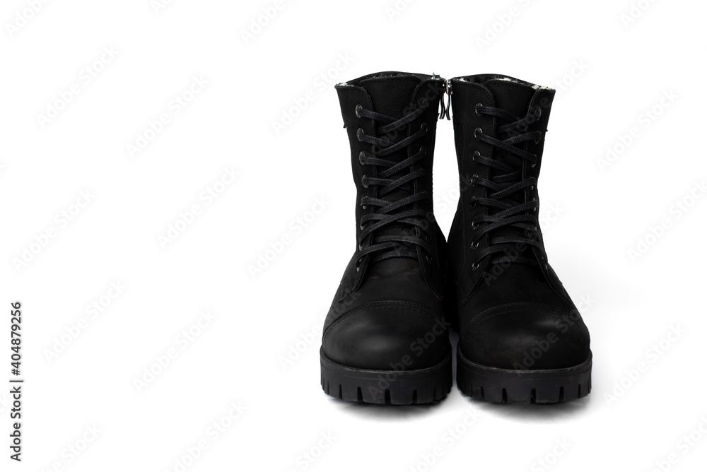 Black winter leather boots isolated on white background.