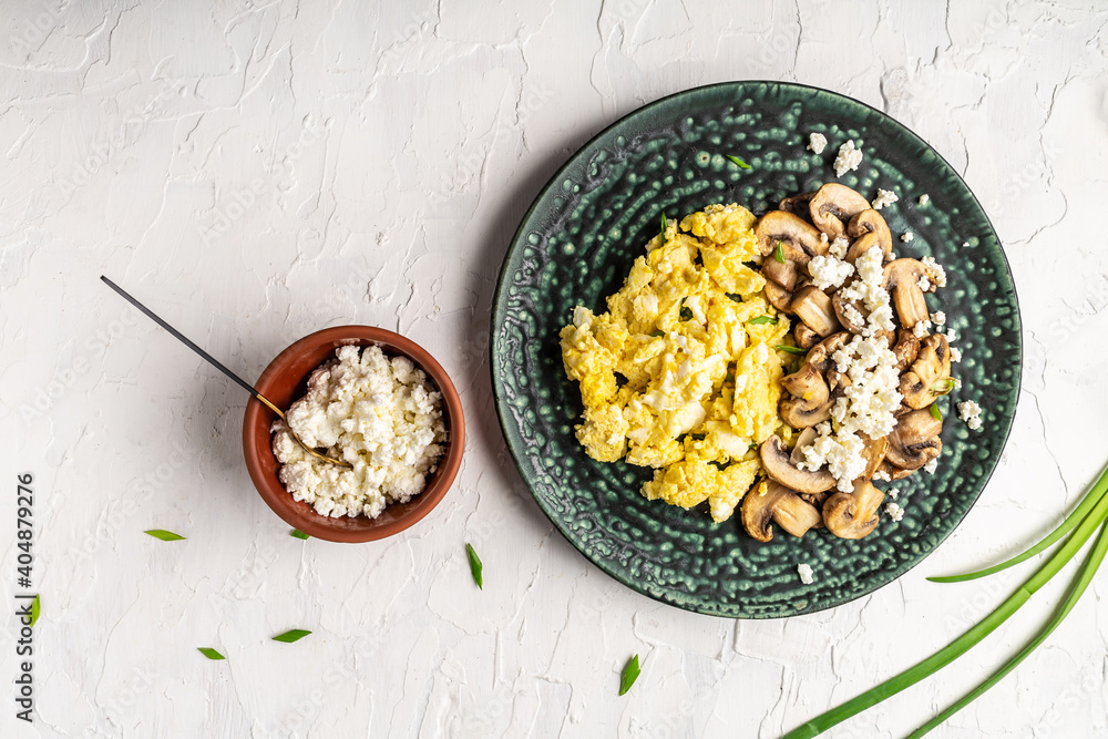 Scrambled eggs with onion and mushrooms on white background, banner
