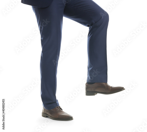 Businessman imitating stepping up on stairs against white background, closeup. Career ladder concept