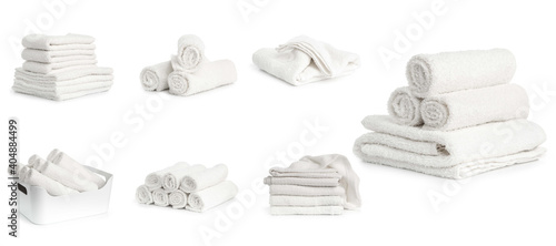 set of white spa towels stacked and in basket isolated on white background