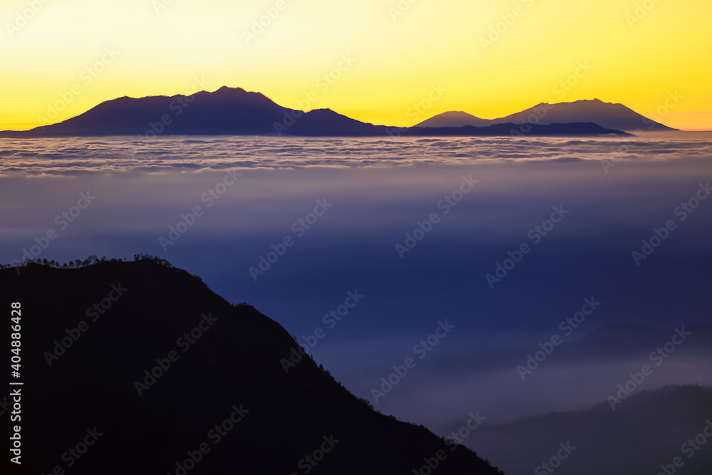 The morning sun and the orange sky above the mountains. Twilight sky background. Colorful Sunset sky and cloud. vivid sky in twilight time background. Fiery orange sunset  Beautiful.