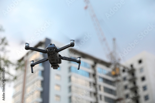 Modern drone flying at building site. Aerial survey