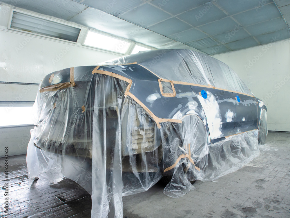car prepared for painting in a spray booth. car prepared for painting in a spray booth.