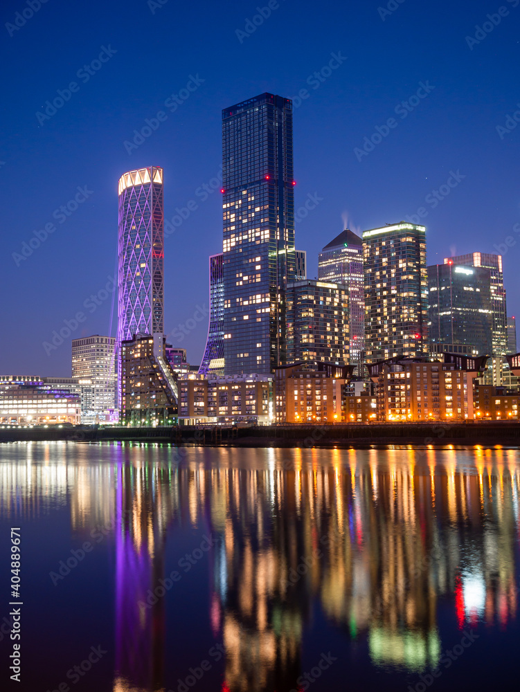 London, England, UK - January 9, 2021: Central Business district, financial buildings of Canary Wharf reflected on the River Thames on the Isle of Dogs