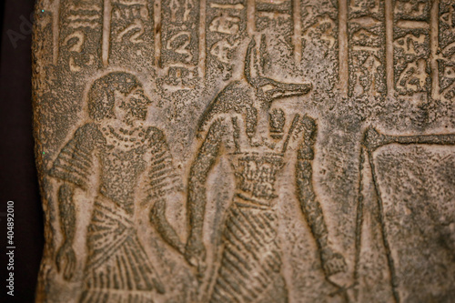 Shallow depth of field (selective focus) and close up footage with Egyptian hieroglyphs on a historic replica. photo