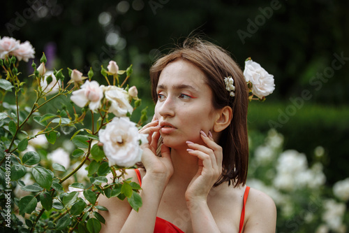 girl in white roses in the garden
