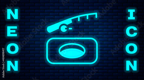 Glowing neon Winter fishing icon isolated on brick wall background. Vector.