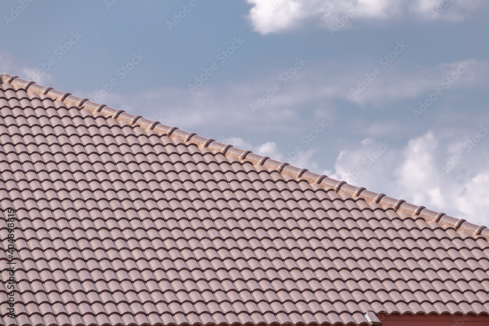 Ceramic roof tiles on the house with blue sky Ceramic roof tiles on the house with blue sky