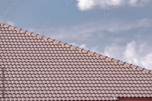 Obraz na plátne Ceramic roof tiles on the house with blue sky