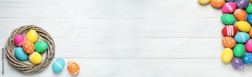 Flat lay composition with colorful Easter eggs on white wooden background, space for text. Horizontal banner design Flat lay composition with colorful Easter eggs on white wooden background, space for text. Horizontal banner design