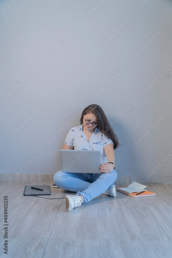 Women working on his laptop on the floor. Work and study at home concept Women working on his laptop on the floor. Work and study at home concept