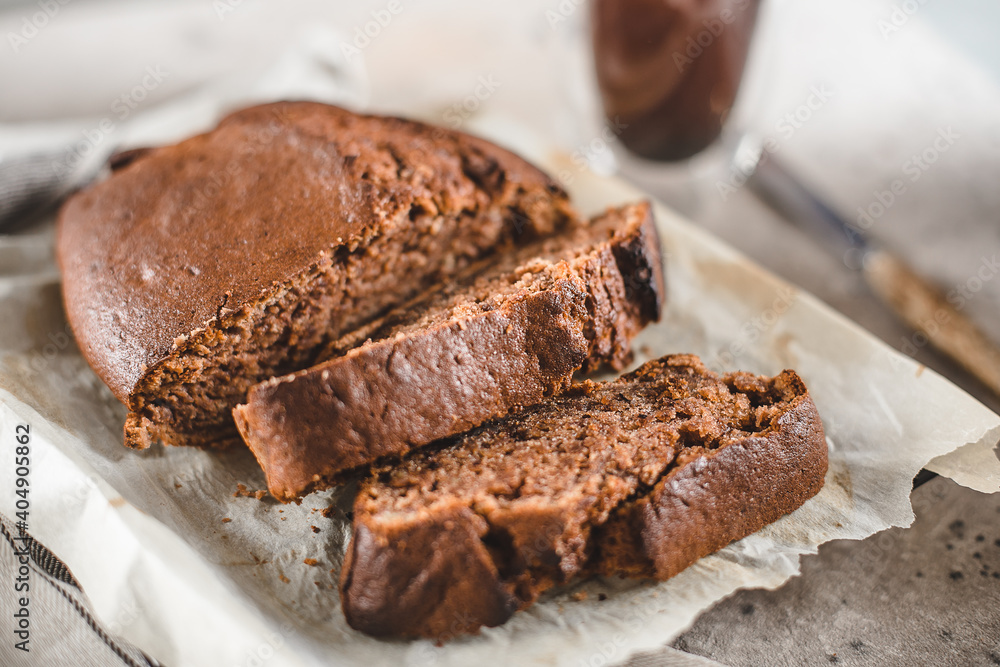 Banana bread sliced with coffee. Vegan pasrty. Home bakery concept. Close-up Banana bread sliced with coffee. Vegan pasrty. Home bakery concept. Close-up