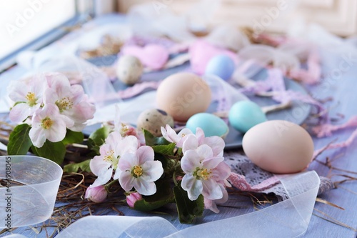 Eggs, Easter decorations, apple-tree flowers on a wooden surface by the window