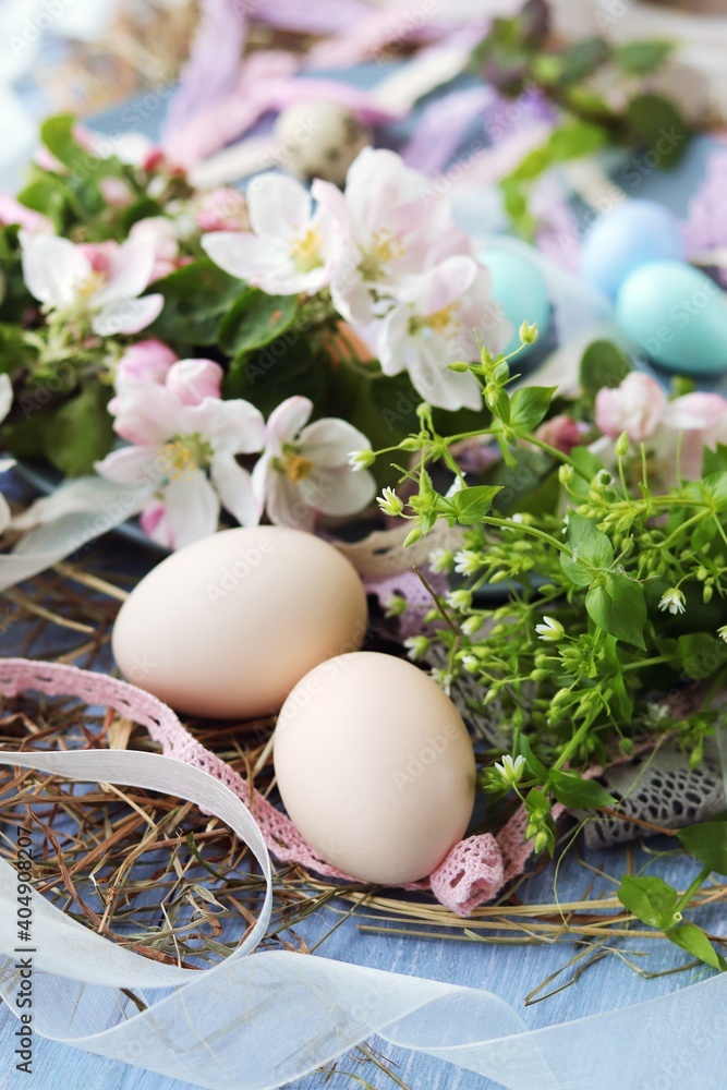 Eggs, Easter decorations, apple-tree flowers on a wooden surface by the window Eggs, Easter decorations, apple-tree flowers on a wooden surface by the window