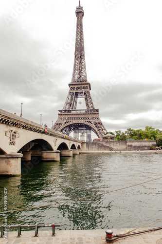 View to the Eiffel tower and bridge over the river in Paris