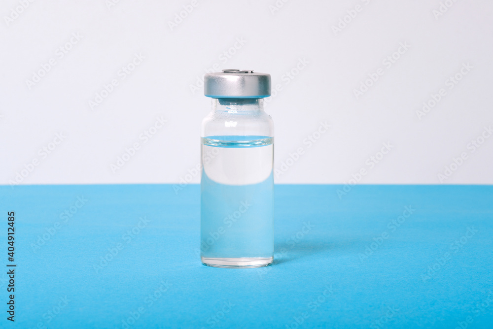 Glass bottle with clear liquid. Vaccine against covid-19. Antibiotics for the treatment of infections and diseases. Health care Glass bottle with clear liquid. Vaccine against covid-19. Antibiotics for the treatment of infections and diseases. Health care