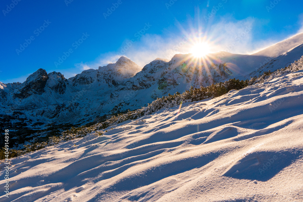 Tatra mountains with swinica in snowy winter time with sun , Kasprowy Wierch, Poland