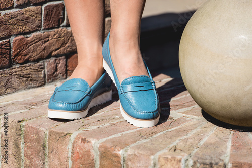 Blue leather moccasins. Photo on the street on the brick stairs. Trendy Blue loafers.