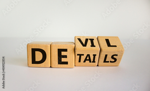 Devil in the details symbol. Turned cubes and changed the word 'details' to 'devil'. Beautiful white background. Business and devil in the details concept. Copy space.