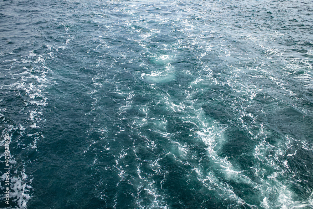 Large waves with sharp gusts of wind top view water