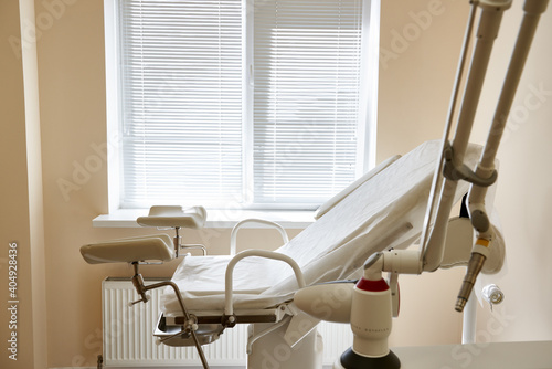 Gynecological chair in the clinic. gynecology room, medical instruments, interior of the genicology clinic photo