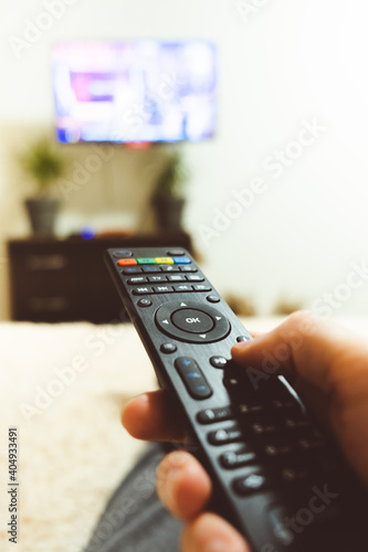hand holding tv remote close-up