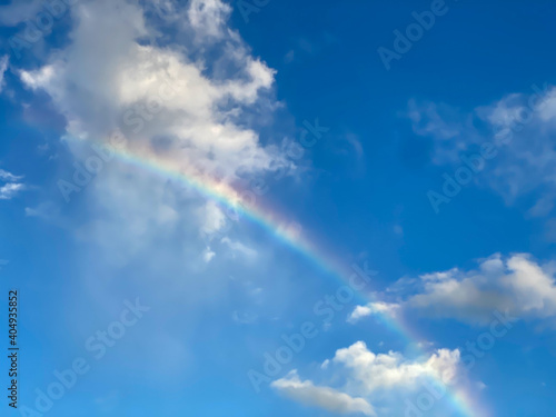 Beautiful rainbow with blue cloudy sky over Reunion island
