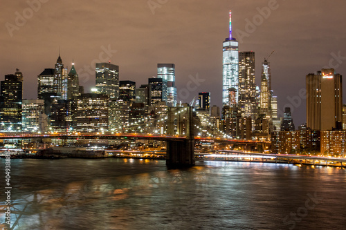 Panoramic View on Manhattan Skyline and Brooklyn Bridge at Night 