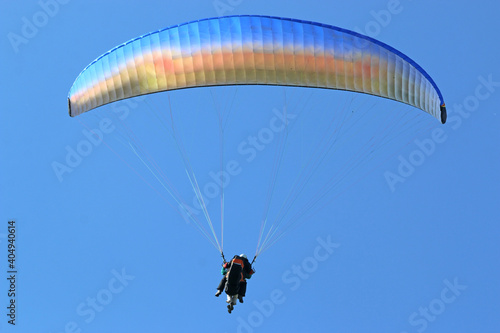  Paraglider flying wing in a blue sky 