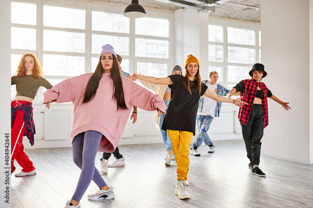 young dancers in colorful wear having fun dancing hip-hop, enjoy being active. lifestyle, youth generation