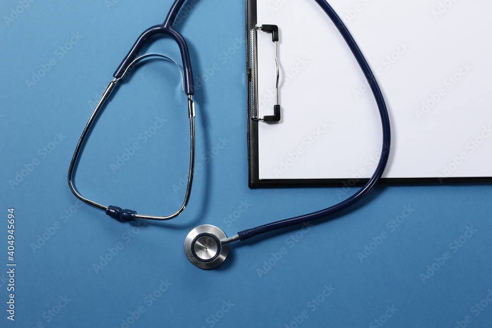 Stethoscope and tablet for recording patients on blue background Stethoscope and tablet for recording patients on blue background