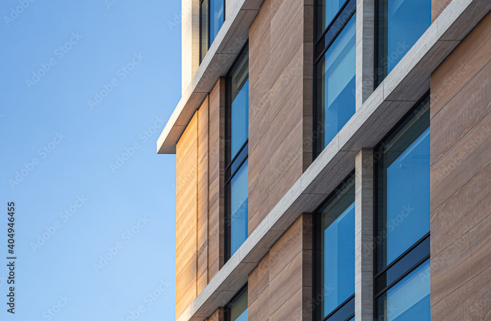 Reflection of blue sky in the windows of a modern office building