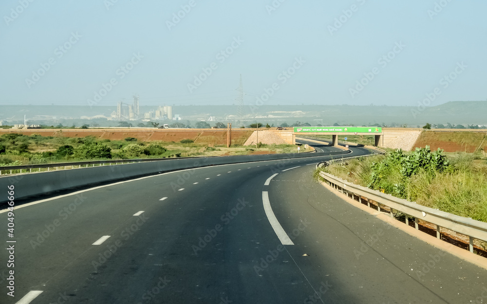 paved road of africa with industry in the background paved road of africa with industry in the background