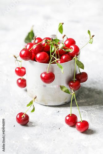 cherries in the cup on light background